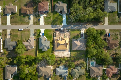 Preview: Aerial view of suburban private house wit wooden roof frame under construction in Florida