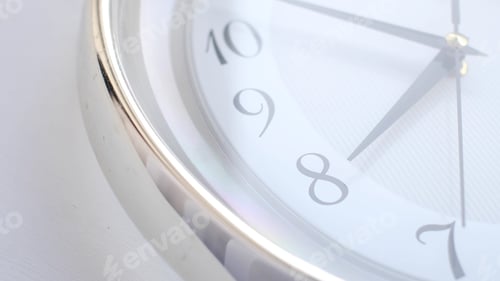 Preview: White clock face ticking. Close-up soft focus.