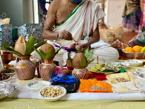 Man Preparing Traditional Ceremony with Coconuts and Offerings