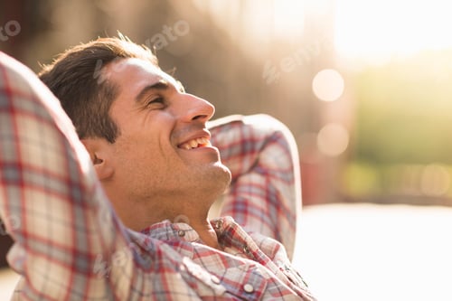 Preview: Young man wearing checked shirt, smiling