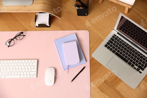 Preview: Stylish workplace with computer keyboard, mouse, laptop and stationery on wooden desk, flat lay