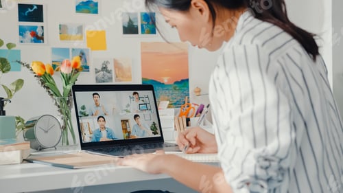 Preview: Young asia female listen leader on video call with colleagues on online with laptop at home.