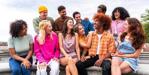 Preview: Happy playful multiethnic group of young friends bonding outdoors