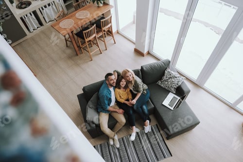 Preview: Top View Portrait Of Happy Family Spending Time Together At Home. They Looking Away And Smiling