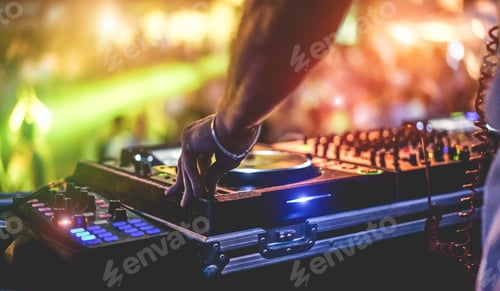 Preview: Dj mixing outdoor at beach party festival with crowd of people in background
