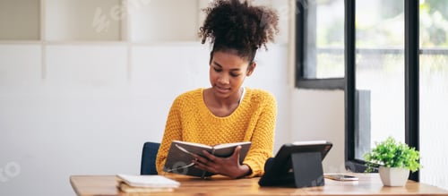 Preview: Teenage Girl Reading Book at Wooden Desk