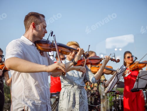 Preview: Violin players having orchestral rehearsal on the street