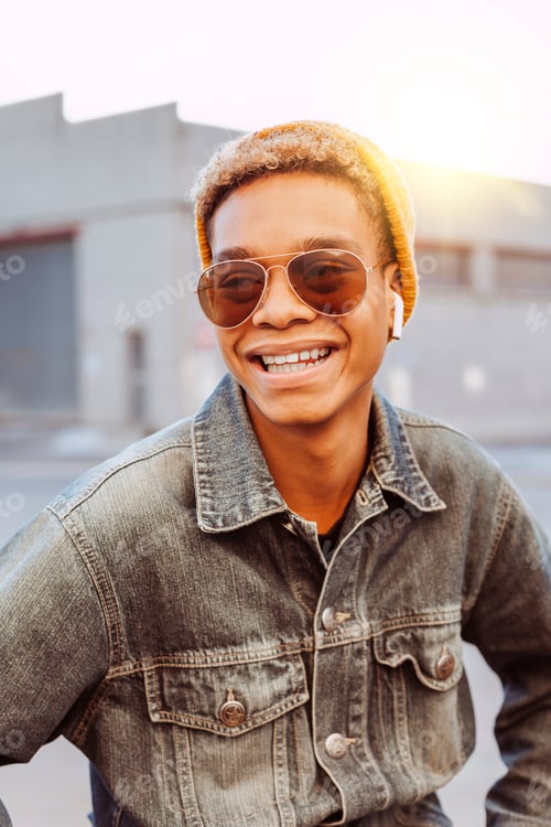 Smiling Man Wearing Denim Jacket and Sunglasses
