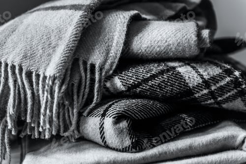Preview: Stack of woolen checked blankets