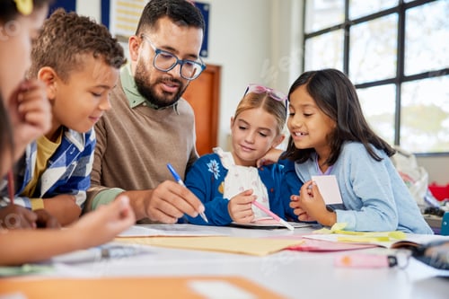 Preview: Teacher checking children homework at school