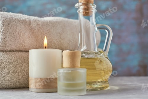 Preview: Towels, candle and massage oil on white table
