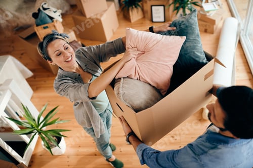 Preview: Above view of happy couple moving into their new home.