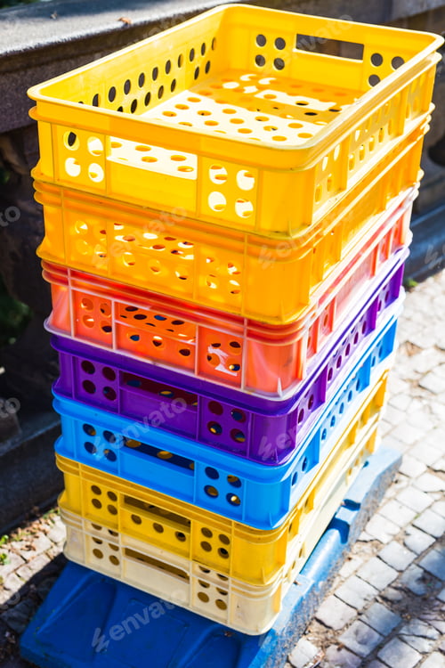 Preview: Colourful industrial plastic crates stuck up on top of each other