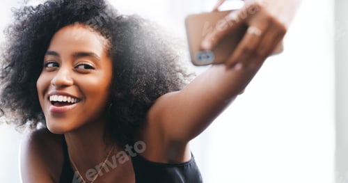 Preview: Shot of a confident young woman taking a selfie with her smartphone