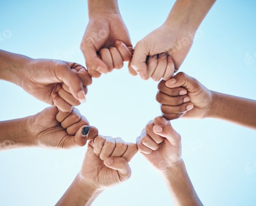 Preview: Hands, fist and people in circle with low angle for trust, solidarity and motivation on blue sky ba
