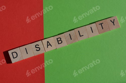 Preview: The word Disability in wooden letters on a red and green background with copy space
