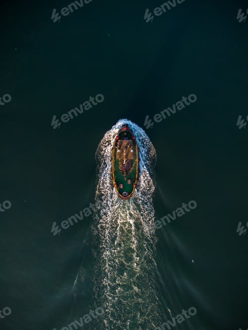 Preview: Aerial drone view of industrial tug assisting boat in deep sea