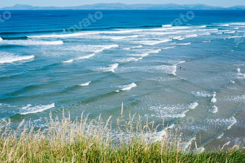 Preview: Serene waves rolling onto the sandy shores of Finner Beach in Donegal,