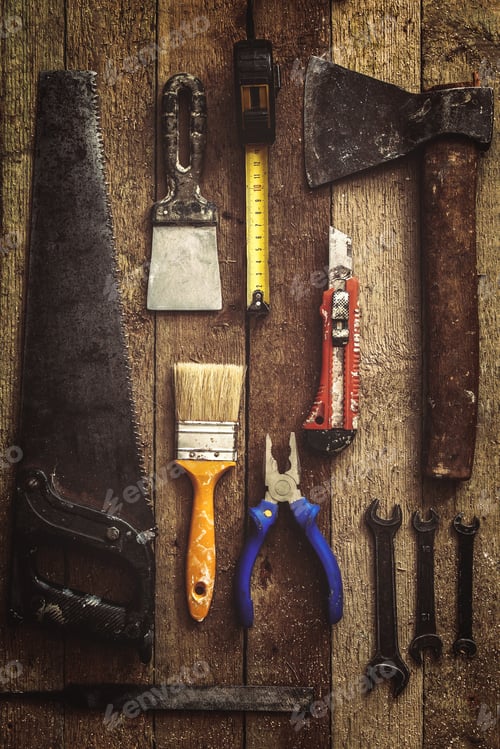 Preview: Old and dirty construction tools on wooden background