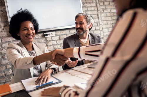 Preview: Business recruiters shakes hands with candidate during job interview.