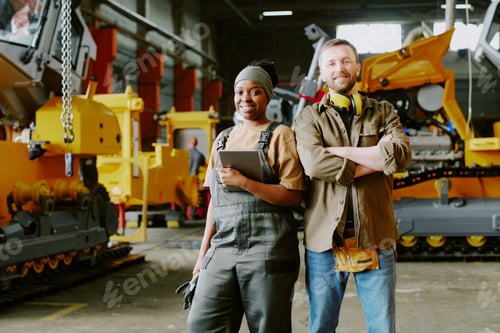 Preview: Two Cheerful Ethnically Diverse Factory Workers
