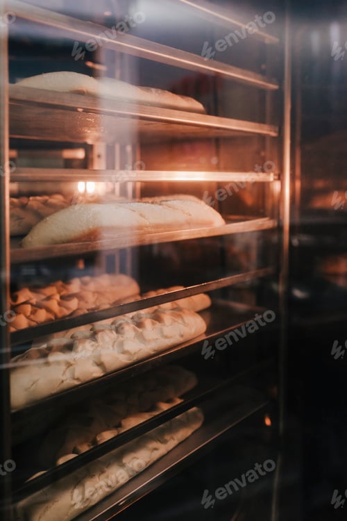 Preview: bread baking in oven. Production oven at the bakery. Baking bread. Manufacture of bread