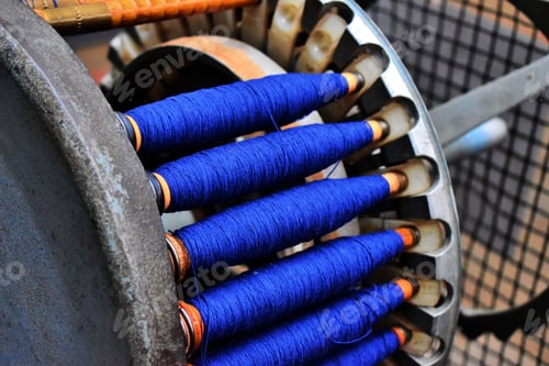 Preview: Closeup of a blue yarn rolls for a loom