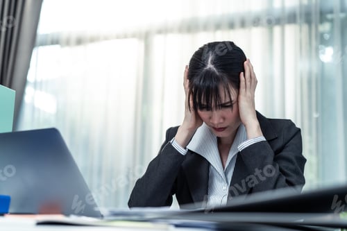 Preview: Exhausted attractive Asian business woman worker look to many paper work on table at workplace