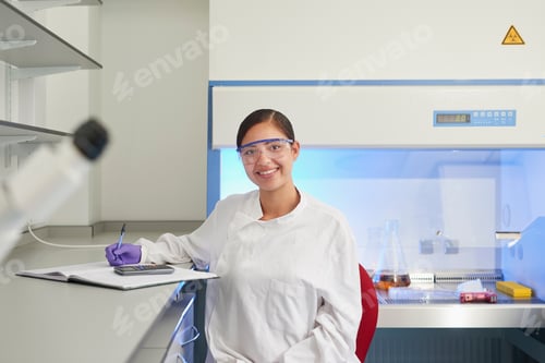 Preview: Portrait of scientist in laboratory looking at camera smiling