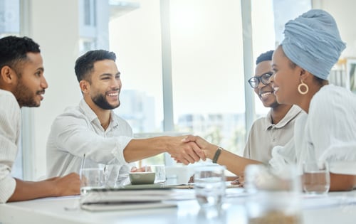Preview: Cropped shot of two young diverse businesspeople shaking hands during a meeting in the boardroom