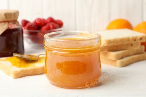 Preview: Composition with apricot jam on white wooden background. Sweet breakfast