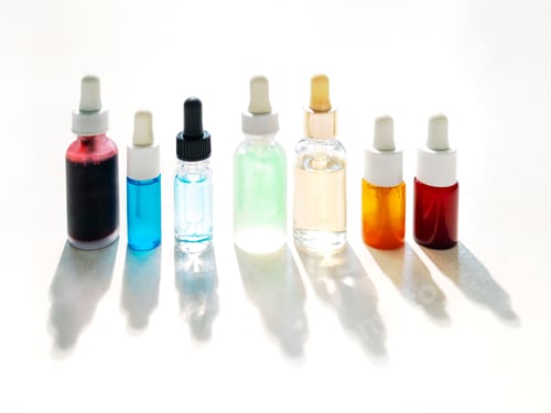Preview: Serum with collagen and peptides in colorful glass bottles on light background