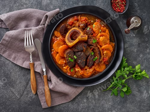 Preview: Ossobuco. Steak veal bake or stew with vegetable sauce and spices on an old concrete table backgroun