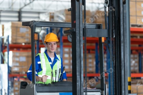 Preview: Worker in auto parts warehouse use a forklift to work to bring the box of auto parts