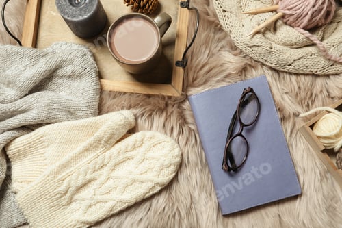 Preview: Flat lay composition with book, wool balls and cup of coffee on fuzzy rug