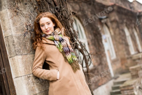 Preview: Young woman by the wall