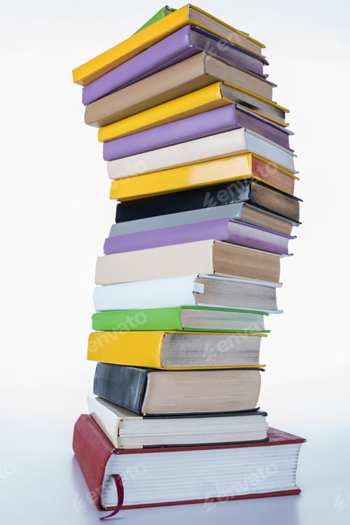 Preview: pile of colored books on white surface