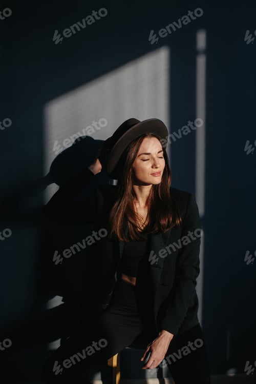 Preview: Fashion portrait of a beautiful girl in a black suit.