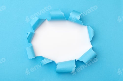 Preview: Blue paper with ripped hole in the middle background