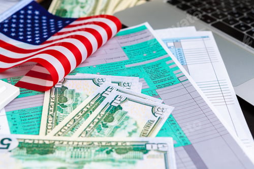 Preview: tax concept - 1040 tax form, pen, us money and flag