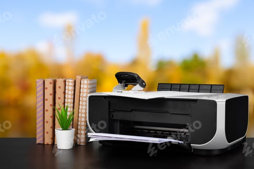Preview: Compact home printer on desk with books against blurred background