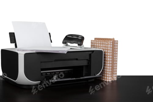 Preview: Printer and stack of books on black table against white background