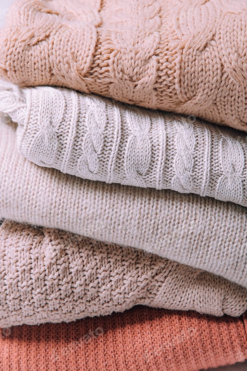Preview: Pile of Cozy Knitted Sweaters in Pastel Colors
