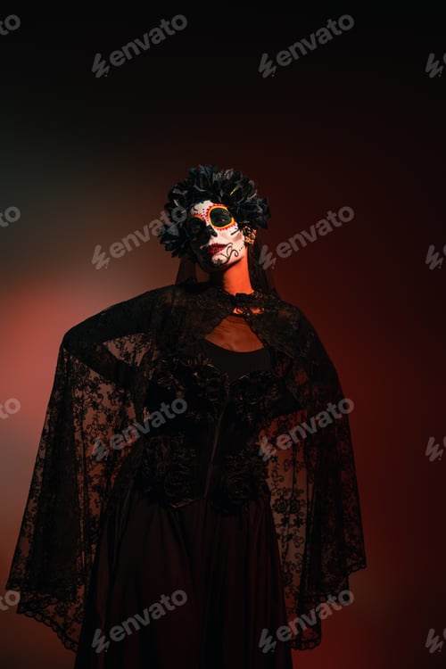 Preview: Woman in santa muerte halloween costume standing on burgundy background