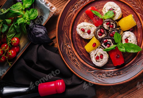 Preview: Gourmet stuffed eggplants and peppers with pomegranate and basil on wooden table