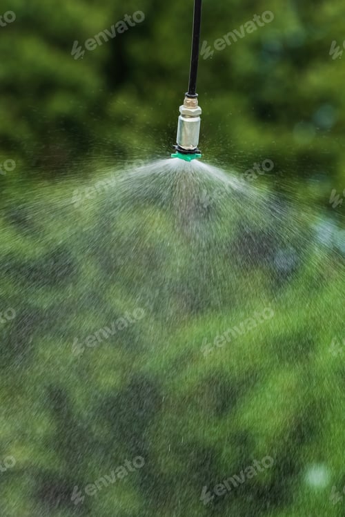 Preview: Vertical image of agricultural sprinkler spraying water outdoors
