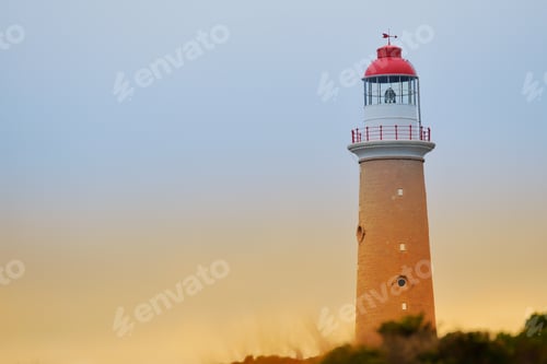Preview: A lighthouse set against a morning sky at dawn