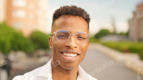 Preview: Man Smiling Outdoors Wearing Glasses and White Shirt