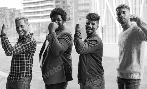 Preview: Young diverse male friends showing muslce biceps in the city