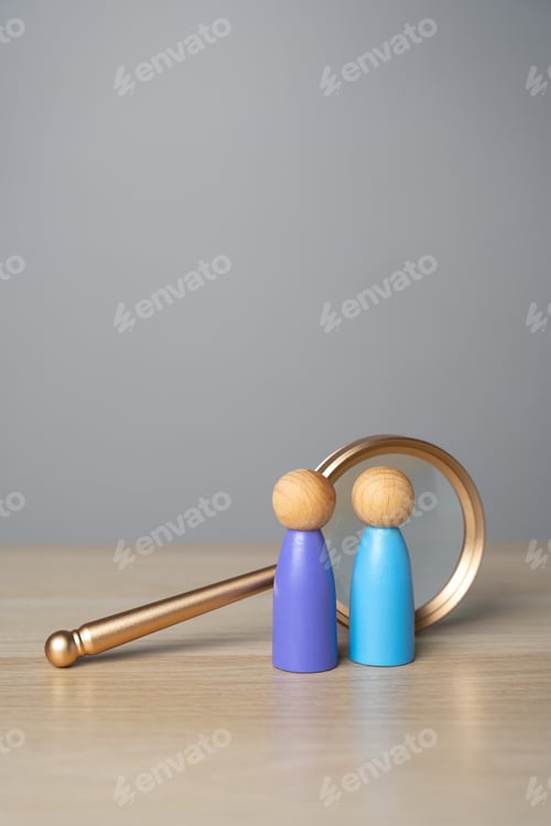 Preview: Wooden Figures with Magnifying Glass on a Wooden Table